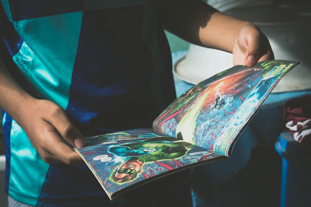 A teenager reading a colorful superhero comic book indoors, enjoying a relaxed moment.